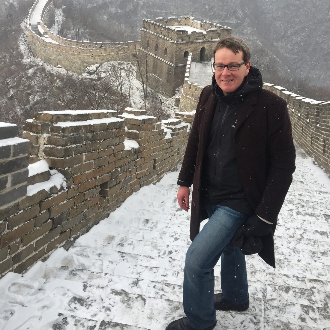 Jonathan Bricker on the Great Wall of China in falling snow.