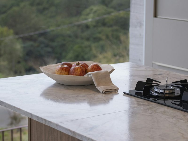 A bowl of fruit on a kitchen counter.