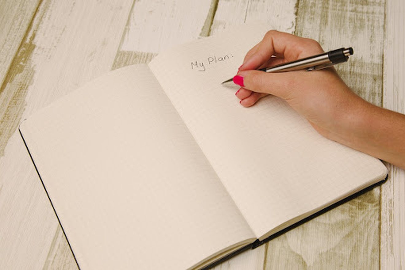 A notebook page reading stick to your plan.